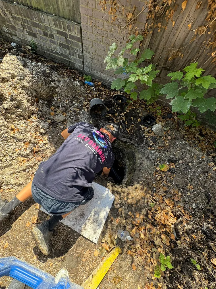 S&V Drainage engineer repairing an excavated garden drain